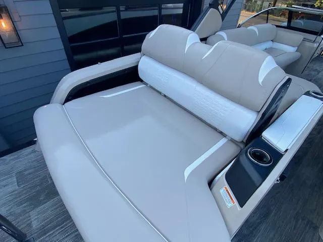 Slide: The Image of 2024 Avalon Catalina 2585 VRB boat with luxurious beige seating and cup holders. - 8