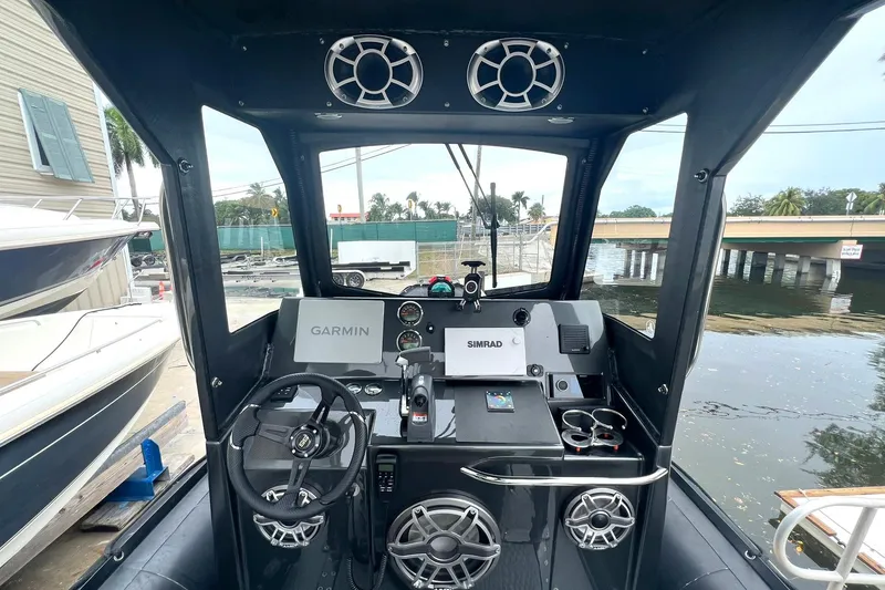 Slide: The Image of Zodiac Milpro Hurricane Custom 2014 boat dashboard with Garmin and Simrad navigation systems. - 11