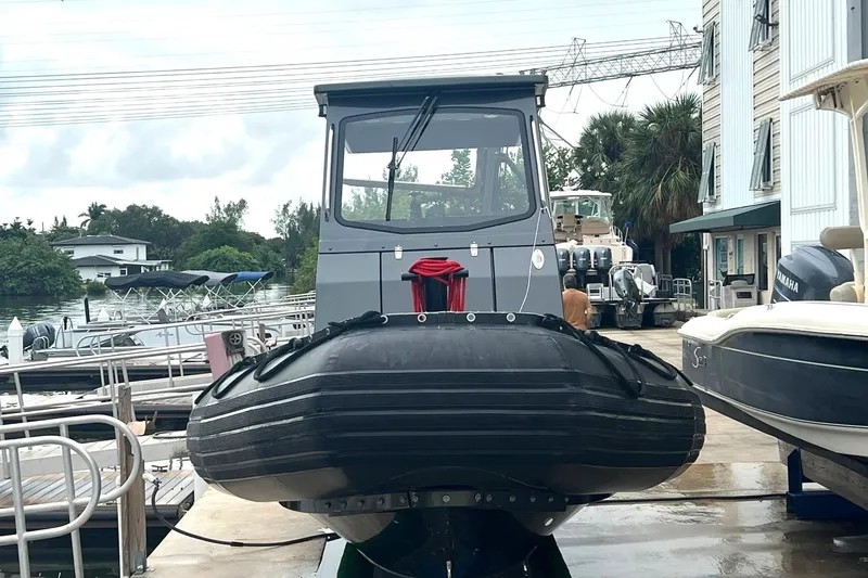 Slide: The Image of 2014 Zodiac Milpro Hurricane Custom boat docked at a marina. - 4