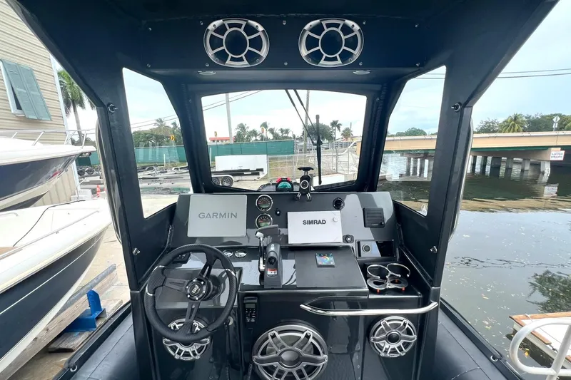 Slide: The Image of 2014 Zodiac Milpro Hurricane Custom boat dashboard with Garmin and Simrad navigation systems. - 12