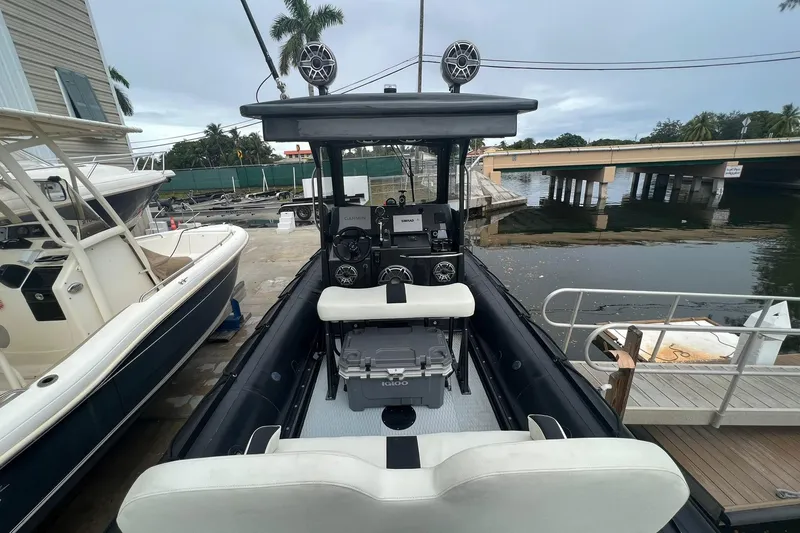 Slide: The Image of Zodiac Milpro Hurricane Custom 2014 boat docked, featuring advanced navigation equipment and seating. - 8