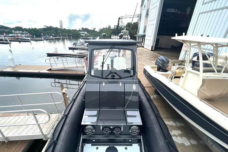 Slide: The Image of 2014 Zodiac Milpro Hurricane Custom boat docked at a marina with other boats. - 6