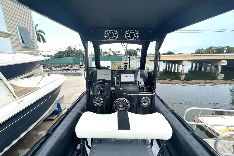 Slide: The Image of 2014 Zodiac Milpro Hurricane Custom boat interior with Garmin and Simrad navigation systems. - 13