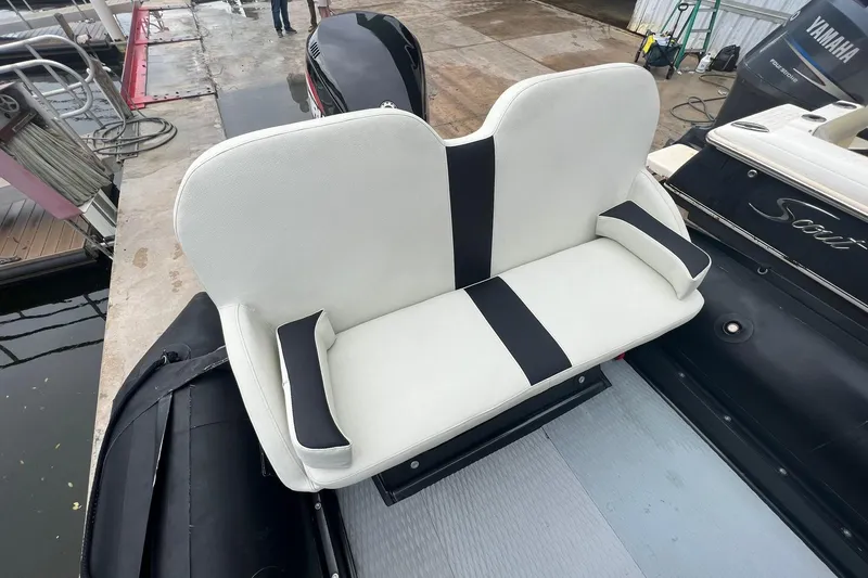 Slide: The Image of Zodiac Milpro Hurricane Custom 2014 boat with white and black seating at dock. - 10