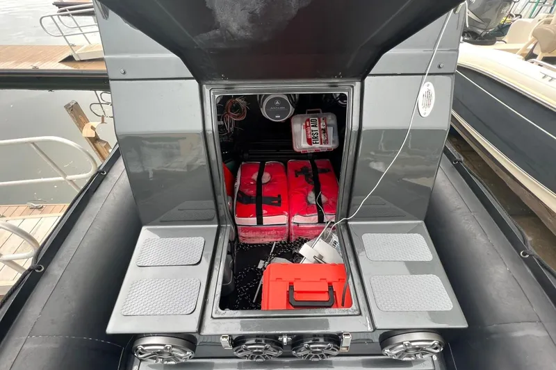 Slide: The Image of Storage compartment of a 2014 Zodiac Milpro Hurricane Custom boat with safety equipment. - 7