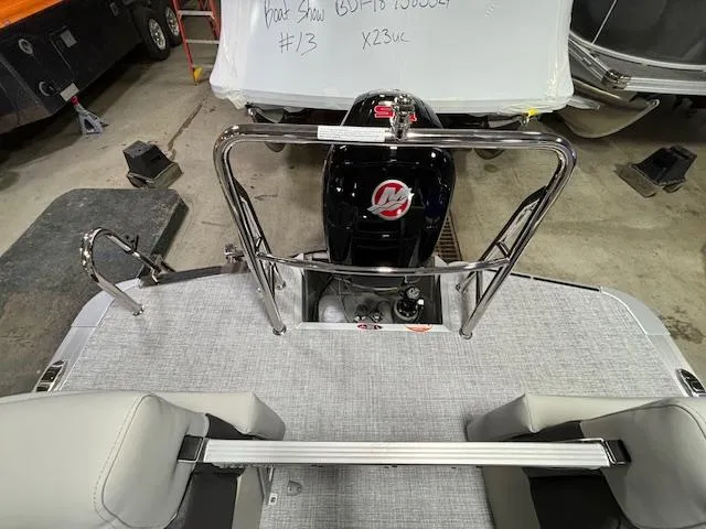 Slide: The Image of 2024 Harris Cruiser 230 CWDH boat interior with motor and seating. - 10