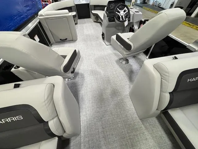 Slide: The Image of 2024 Harris Cruiser 230 CWDH interior with plush seating and modern helm. - 12