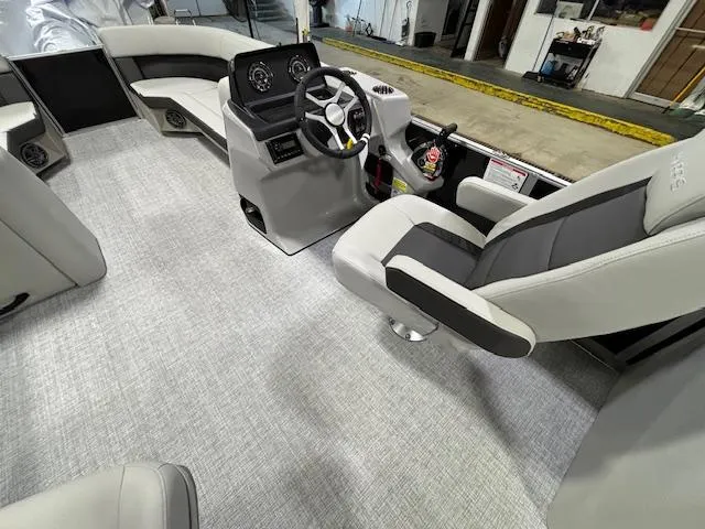 Slide: The Image of 2024 Harris Cruiser 230 CWDH boat interior with modern helm and seating. - 13