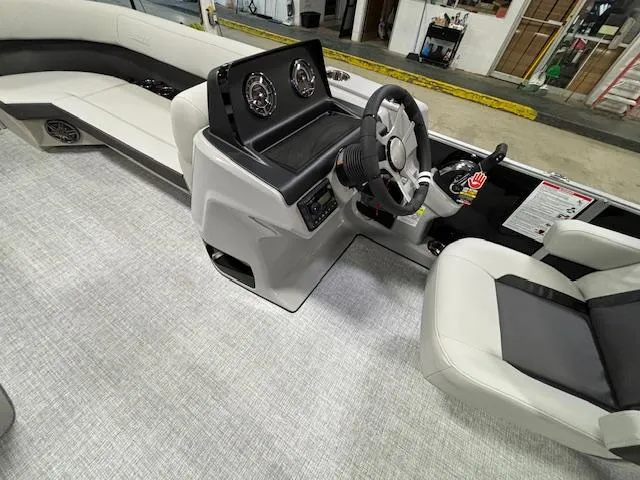 Slide: The Image of 2024 Harris Cruiser 230 CWDH boat interior with steering console and seating. - 14