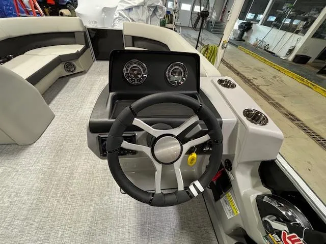 Slide: The Image of 2024 Harris Cruiser 230 CWDH boat interior with steering wheel and dashboard. - 15