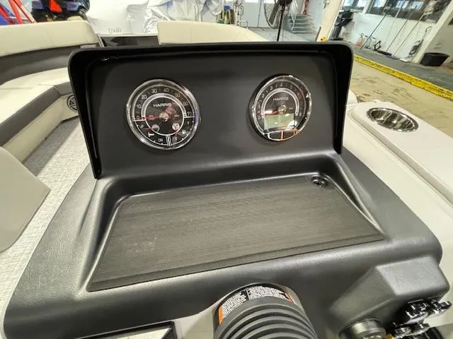 Slide: The Image of Dashboard of 2024 Harris Cruiser 230 CWDH boat with gauges and controls. - 16