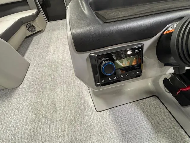 Slide: The Image of 2024 Harris Cruiser 230 CWDH boat interior with audio control panel. - 17