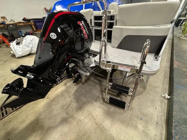 Slide: The Image of 2024 Harris Cruiser 230 CWDH pontoon boat with outboard motor and boarding ladder. - 20