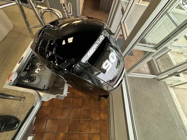 Slide: The Image of 2024 Harris Cruiser 210 CS with Mercury 90 outboard motor. - 12