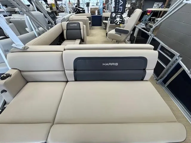 Slide: The Image of 2024 Harris Cruiser 210 CS boat interior with beige seating and Harris branding. - 13