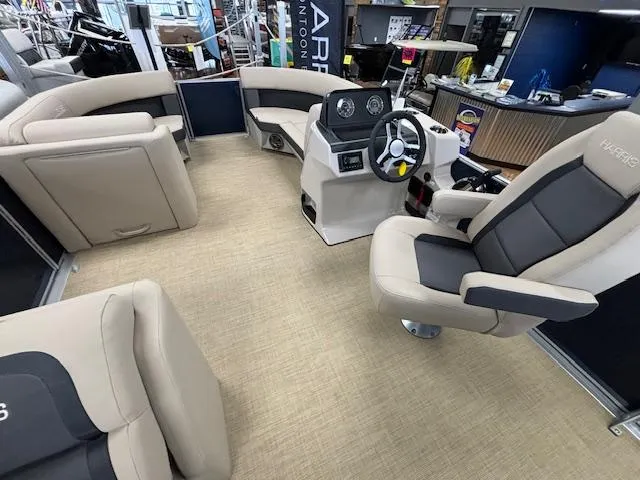 Slide: The Image of 2024 Harris Cruiser 210 CS pontoon boat interior with beige seating and modern helm. - 15