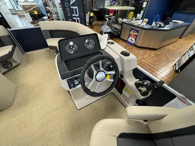 Slide: The Image of 2024 Harris Cruiser 210 CS boat interior with steering wheel and dashboard. - 16
