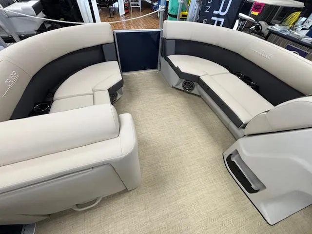 Slide: The Image of 2024 Harris Cruiser 210 CS interior with beige and gray seating. - 21