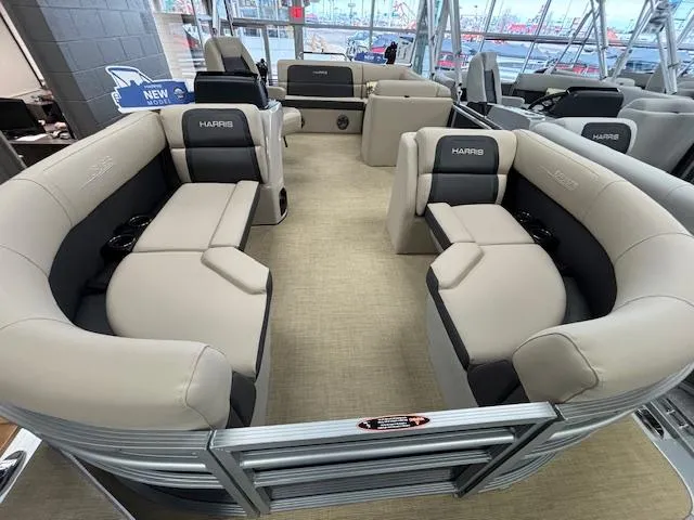 Slide: The Image of 2024 Harris Cruiser 210 CS pontoon boat interior with beige seating and black accents. - 3
