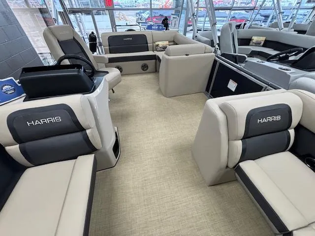 Slide: The Image of 2024 Harris Cruiser 210 CS pontoon boat interior with beige and black seating. - 4
