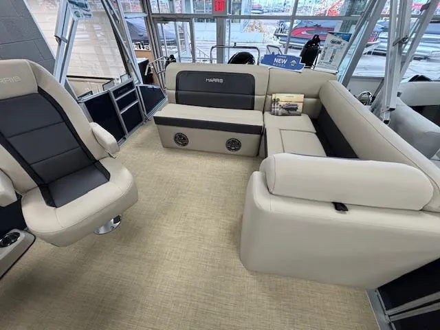 Slide: The Image of 2024 Harris Cruiser 210 CS interior with beige and black seating. - 6
