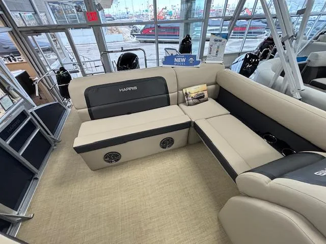 Slide: The Image of 2024 Harris Cruiser 210 CS pontoon boat interior with beige and black seating. - 7