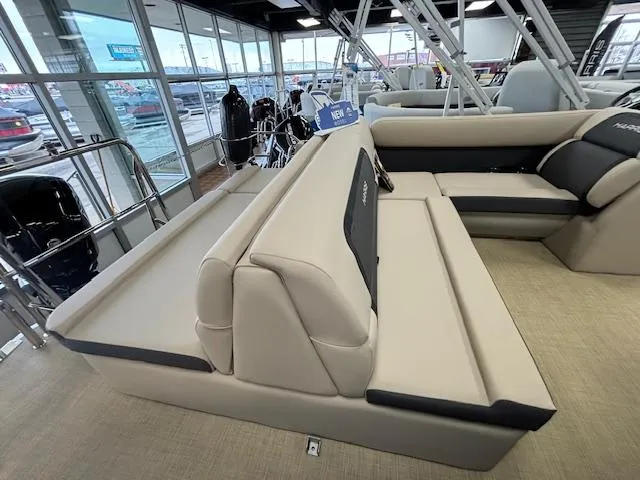 Slide: The Image of 2024 Harris Cruiser 210 CS interior seating in showroom. - 9