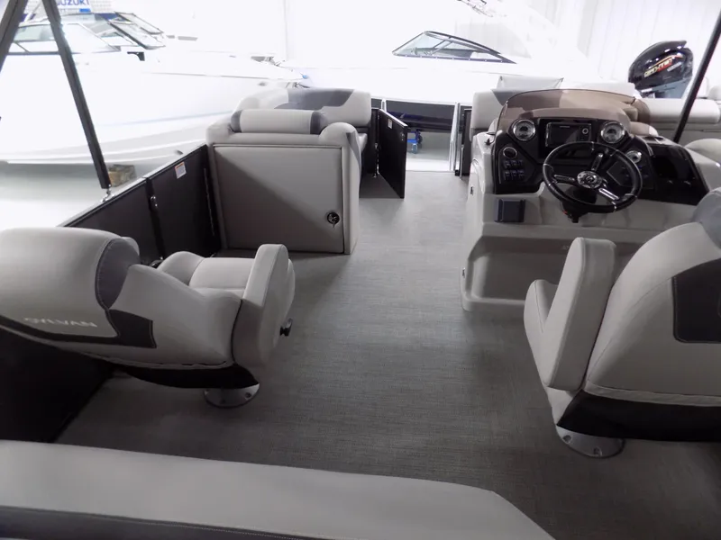 Slide: The Image of 2024 Sylvan L3 DLZ pontoon boat interior with modern seating and steering console. - 3