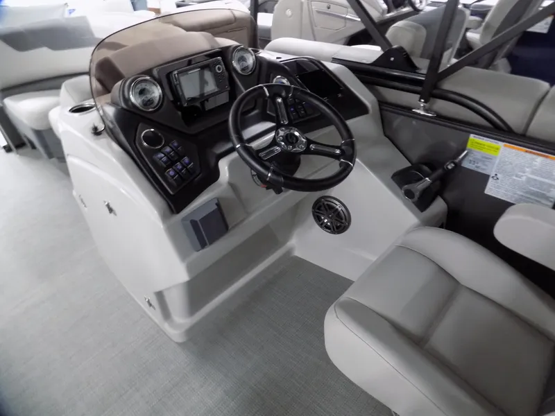 Slide: The Image of 2024 Sylvan L3 DLZ boat interior with modern steering console and seating. - 5
