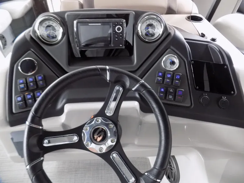 Slide: The Image of 2024 Sylvan L3 DLZ boat dashboard with steering wheel and control panel. - 6