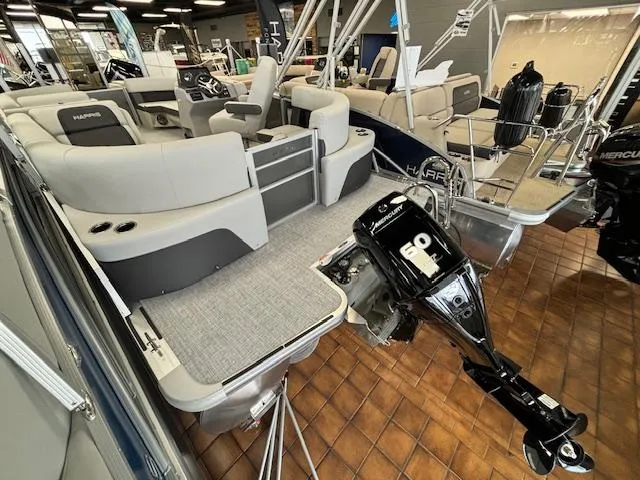 Slide: The Image of 2024 Harris CRUISER 190 CW pontoon boat with 60 HP Mercury outboard motor in showroom. - 10