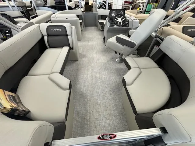 Slide: The Image of 2024 Harris CRUISER 190 CW pontoon boat interior with plush seating and modern helm. - 12