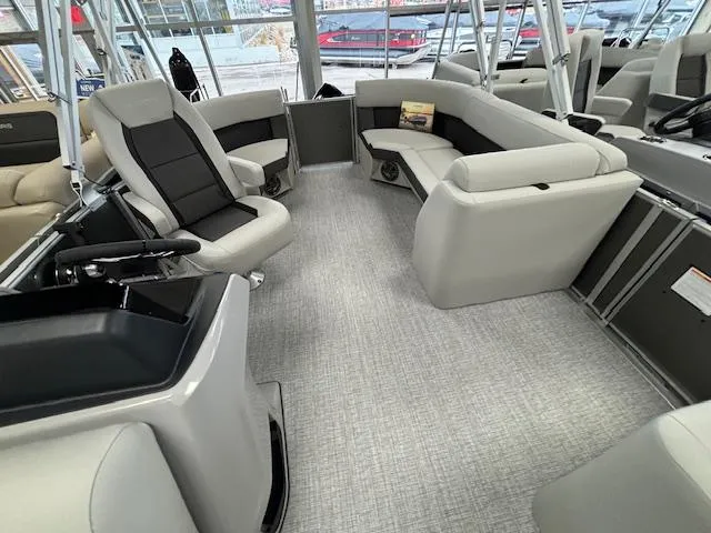 Slide: The Image of 2024 Harris CRUISER 190 CW pontoon boat interior with gray seating and modern design. - 5