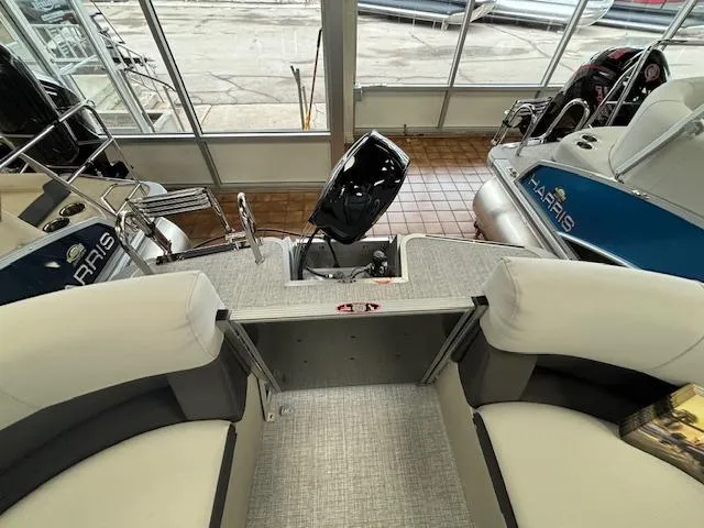 Slide: The Image of 2024 Harris CRUISER 190 CW boat interior with motor and seating. - 8