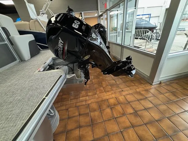 Slide: The Image of 2024 Harris CRUISER 190 CW pontoon boat with Mercury 60 outboard motor in showroom. - 9