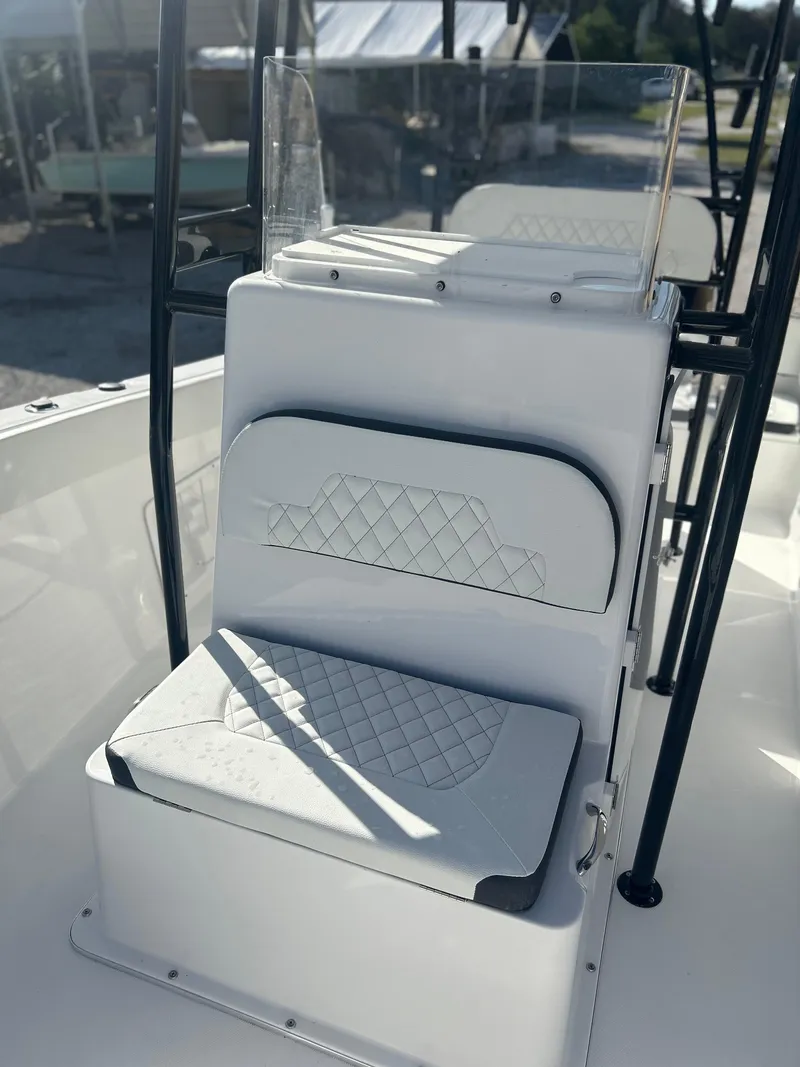 Slide: The Image of 2022 Clearwater 2300 boat with cushioned seating and console. - 10