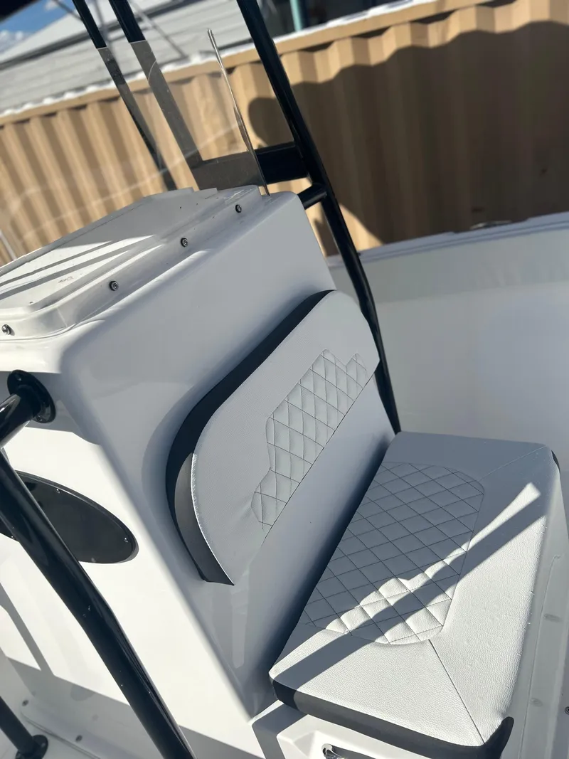 Slide: The Image of 2022 Clearwater 2300 boat with cushioned seating and modern design. - 12