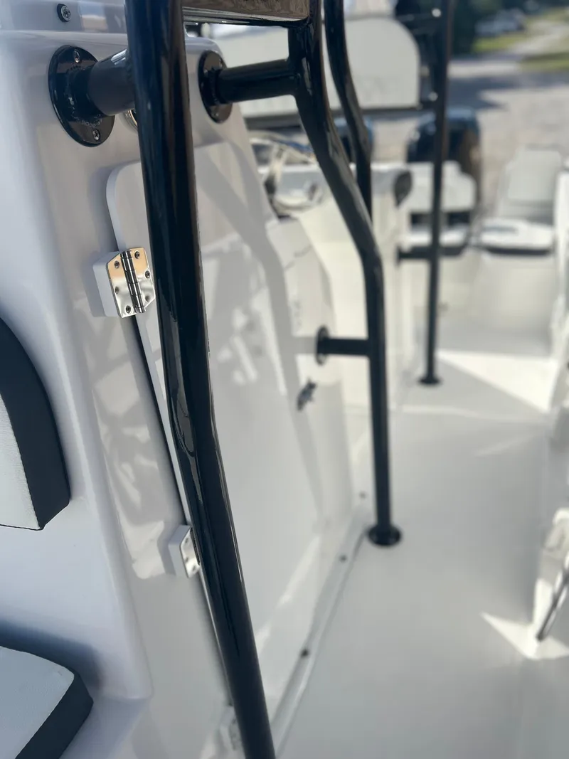 Slide: The Image of 2022 Clearwater 2300 boat interior with black railings and white seating. - 13
