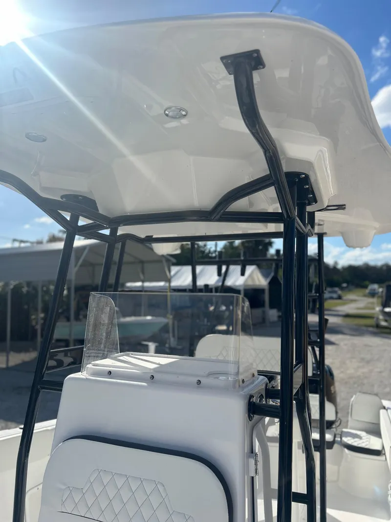 Slide: The Image of 2022 Clearwater 2300 boat with T-top and console in sunlight. - 14