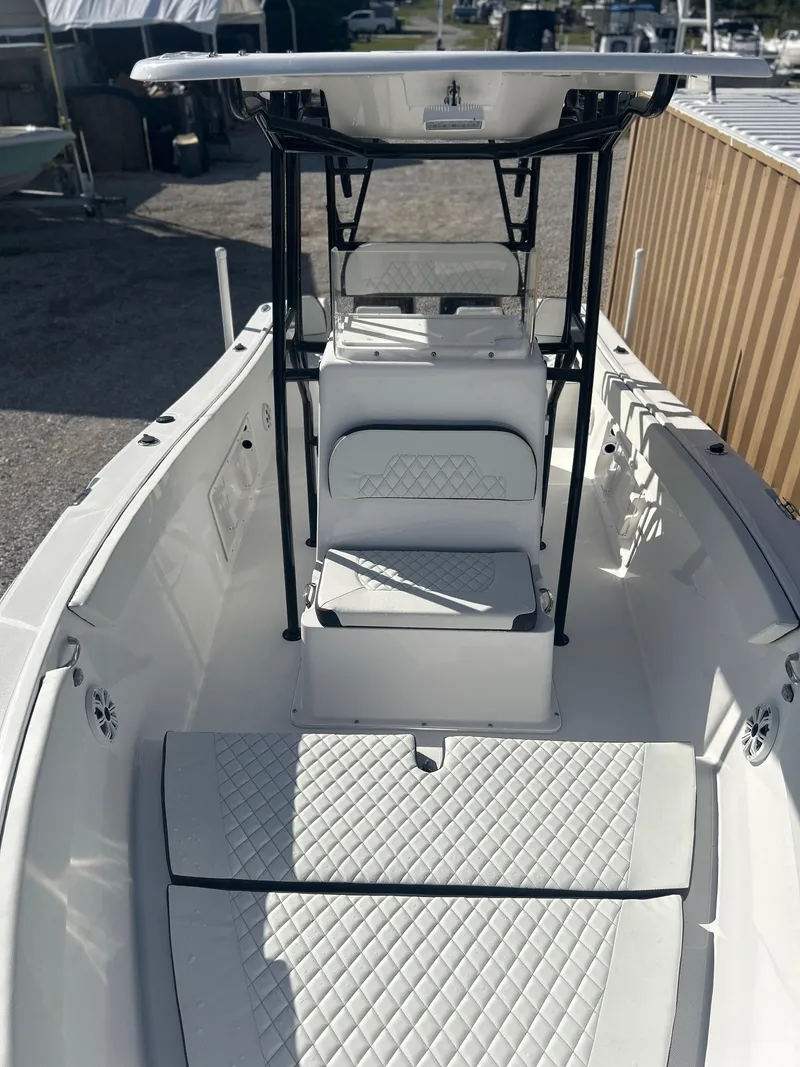 Slide: The Image of 2022 Clearwater 2300 boat interior with white seating and black frame. - 16