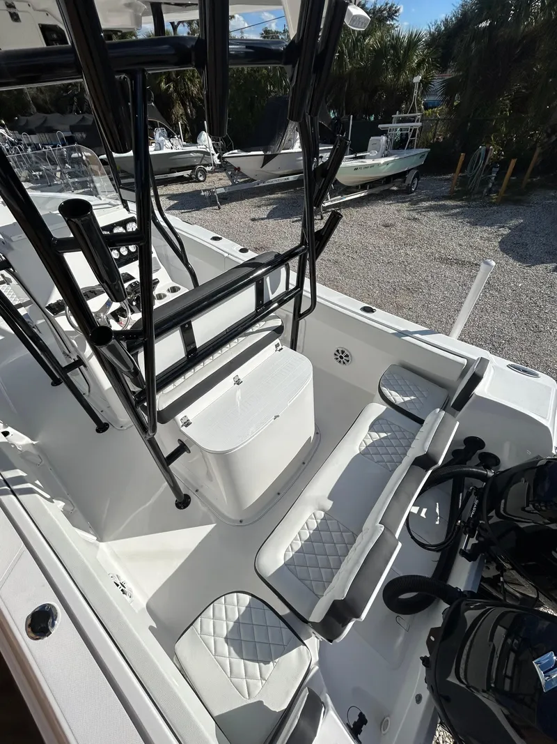 Slide: The Image of 2022 Clearwater 2300 boat interior with seating and storage compartments. - 20