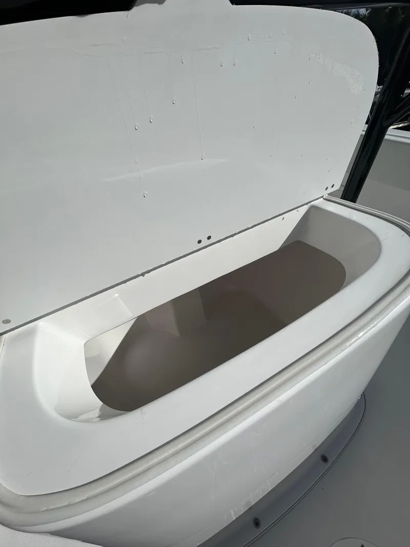 Slide: The Image of Open storage compartment on a 2022 Clearwater 2300 boat. - 21