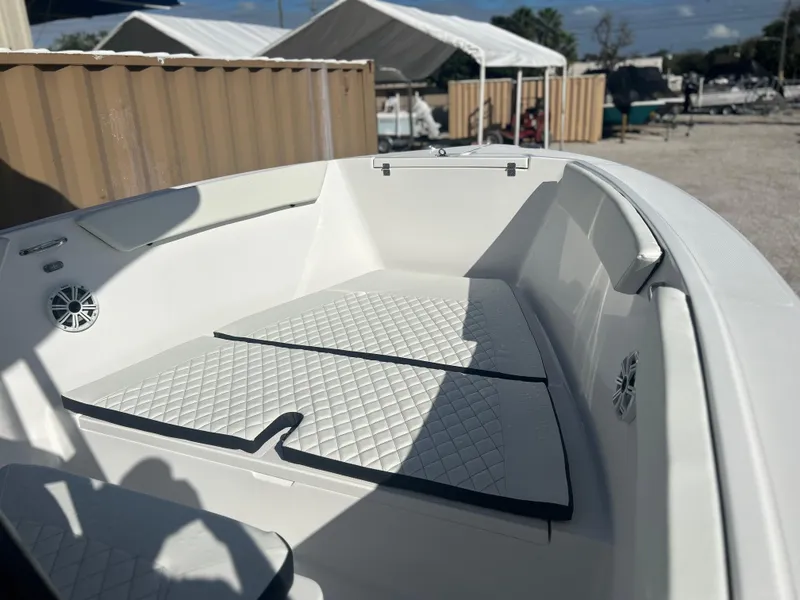 Slide: The Image of 2022 Clearwater 2300 boat interior with cushioned seating and storage compartments. - 23
