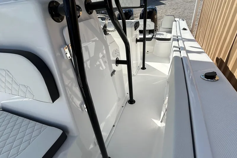 Slide: The Image of 2022 Clearwater 2300 boat interior with white seating and black railings. - 26