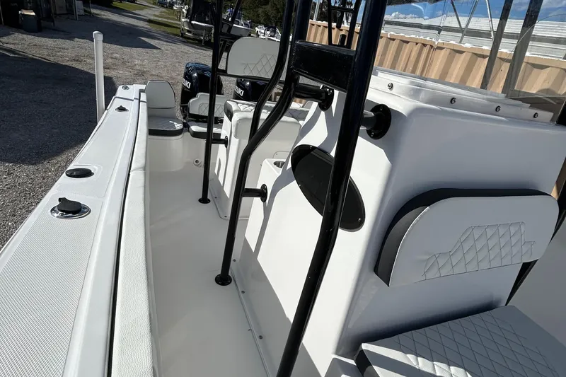 Slide: The Image of 2022 Clearwater 2300 boat interior with seating and storage compartments. - 27