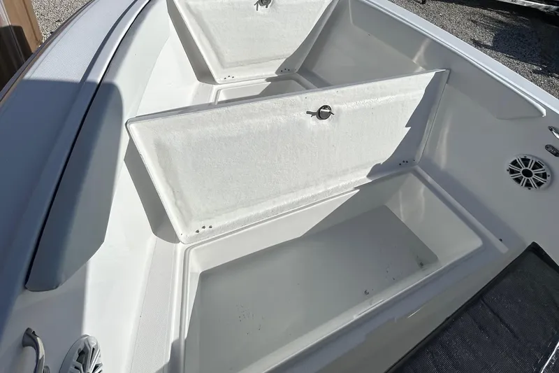 Slide: The Image of 2022 Clearwater 2300 boat with open storage compartments. - 28