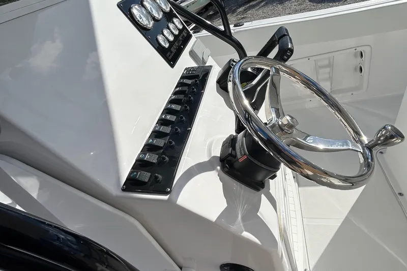 Slide: The Image of 2022 Clearwater 2300 boat console with steering wheel and control panel. - 32