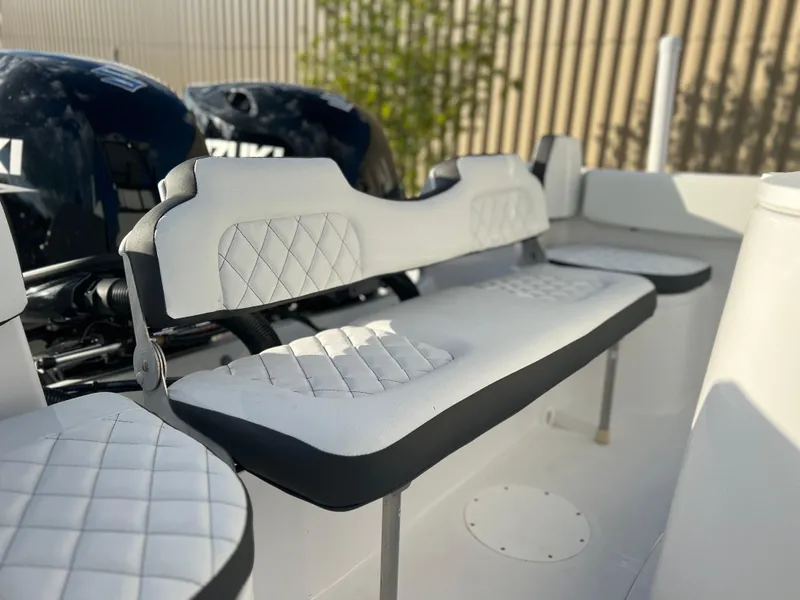 Slide: The Image of Clearwater 2300 2022 boat interior with cushioned seating and dual Suzuki outboard motors. - 5