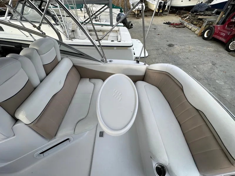 Slide: The Image of 2007 Four Winns 258 Vista boat interior with cushioned seating and table. - 11