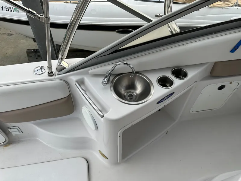 Slide: The Image of 2007 Four Winns 258 Vista boat interior with sink and cup holders. - 12